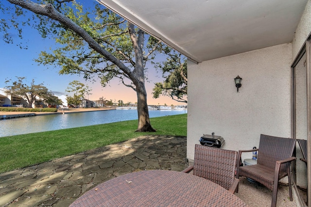 view of patio with a water view