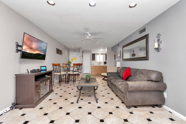 living room featuring a ceiling fan, recessed lighting, visible vents, and baseboards