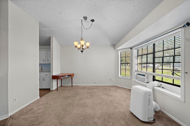 carpeted dining area with a notable chandelier, visible vents, a textured ceiling, cooling unit, and baseboards