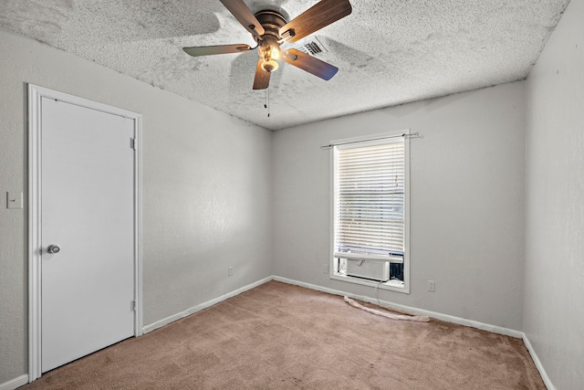 spare room with baseboards, visible vents, ceiling fan, carpet, and a textured ceiling