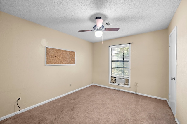 spare room with carpet, cooling unit, visible vents, and baseboards