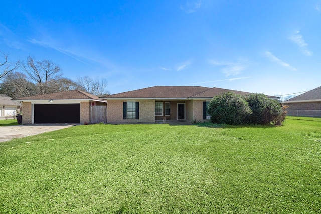 ranch-style home featuring a garage, driveway, brick siding, and a front yard