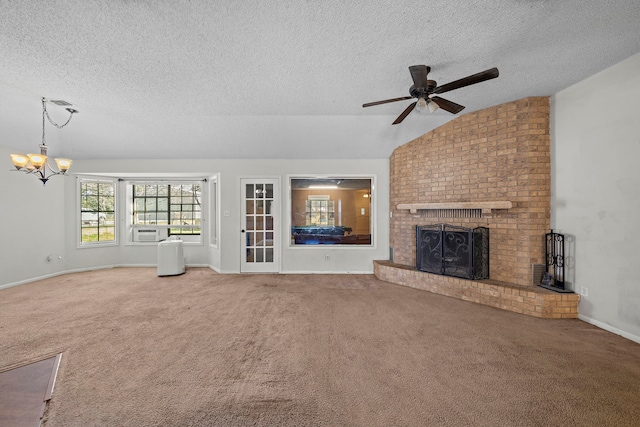 unfurnished living room featuring lofted ceiling, a textured ceiling, cooling unit, carpet floors, and a brick fireplace