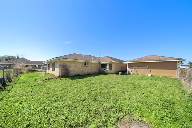 back of property featuring a fenced backyard and a lawn