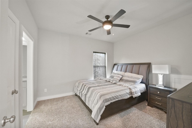 bedroom featuring a ceiling fan, light colored carpet, visible vents, and baseboards