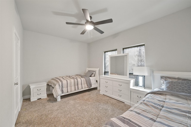 bedroom with a ceiling fan and light colored carpet