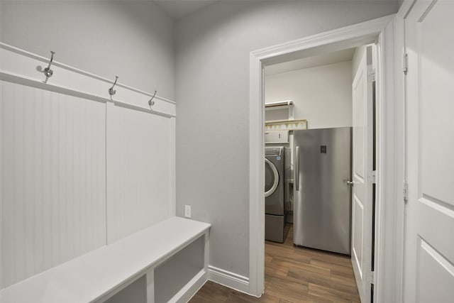 mudroom featuring washer / dryer, dark wood finished floors, and baseboards