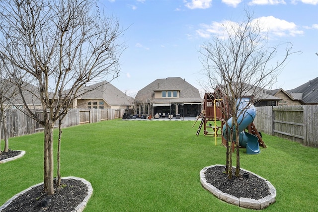 view of yard featuring a playground, a patio, and a fenced backyard