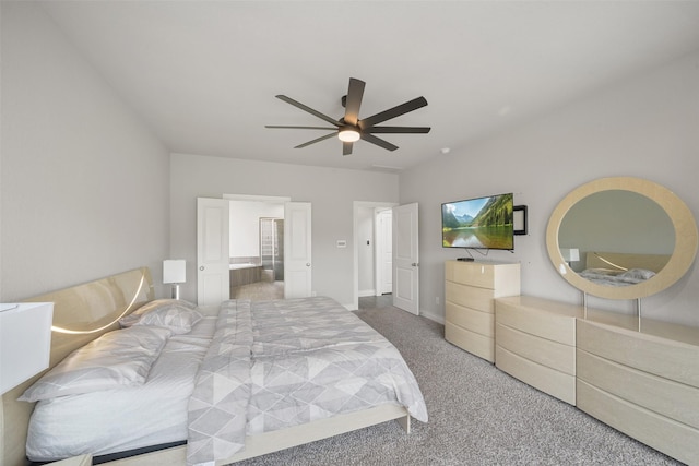 carpeted bedroom with ensuite bathroom and ceiling fan