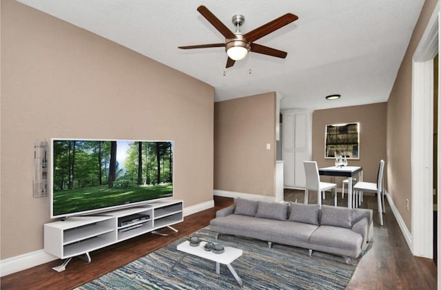 living room with a ceiling fan, baseboards, and wood finished floors