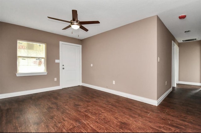 unfurnished room featuring a ceiling fan, baseboards, and wood finished floors