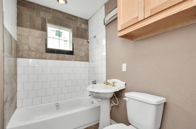 full bathroom with a textured wall, shower / bathing tub combination, and toilet