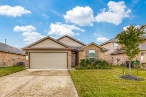 ranch-style home featuring a garage, driveway, and a front lawn