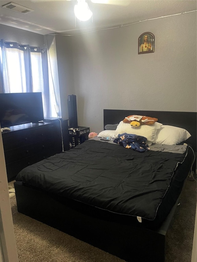 carpeted bedroom featuring visible vents