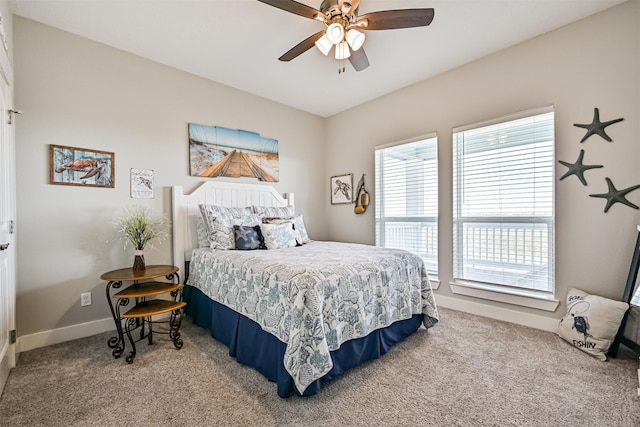 carpeted bedroom featuring a ceiling fan and baseboards