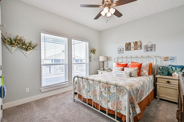 bedroom with ceiling fan, carpet flooring, and baseboards