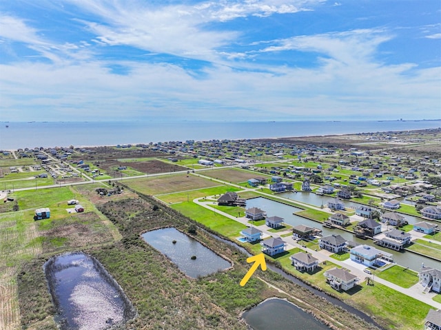 bird's eye view featuring a water view and a residential view