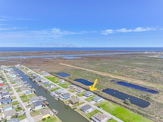 drone / aerial view with a water view and a residential view