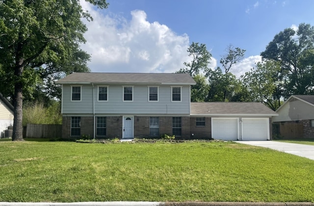 view of front facade with fence, an attached garage, brick siding, concrete driveway, and a front yard