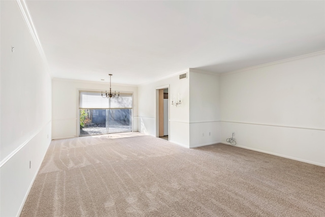 carpeted spare room featuring visible vents, crown molding, baseboards, and an inviting chandelier