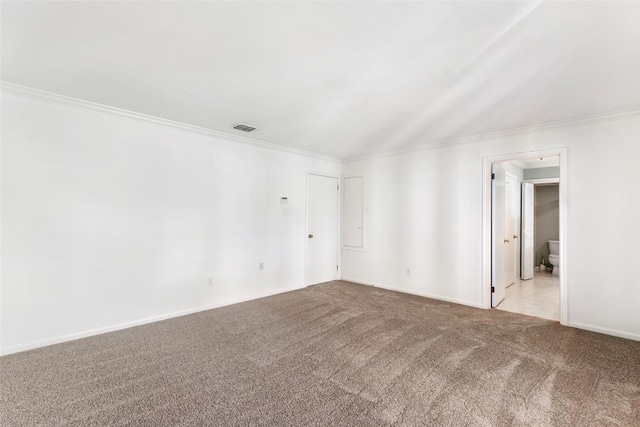 carpeted spare room with visible vents, crown molding, and baseboards