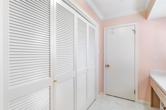 bathroom with ornamental molding, a closet, vanity, and baseboards