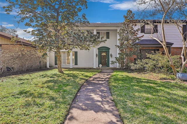 view of front of property with a front yard and brick siding