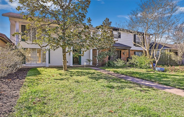 view of front facade featuring a front lawn and brick siding