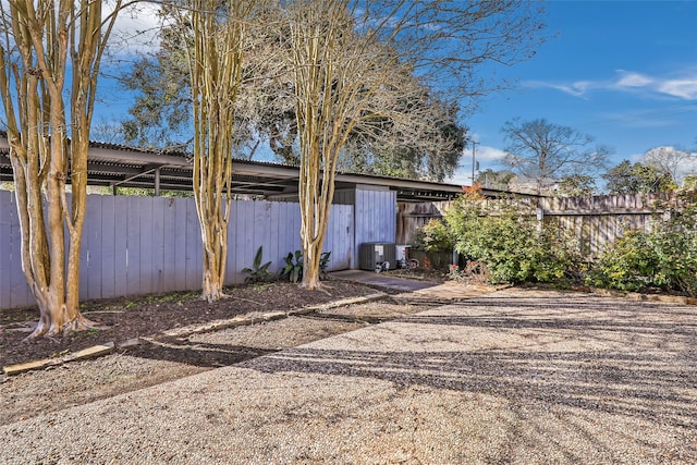 exterior space featuring central AC, fence, and driveway