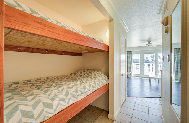 bedroom featuring a textured ceiling and tile patterned floors