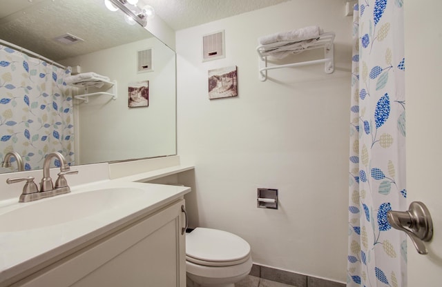 bathroom featuring visible vents, a textured ceiling, toilet, and vanity