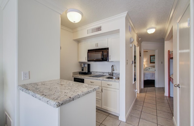 kitchen with visible vents, crown molding, and black appliances