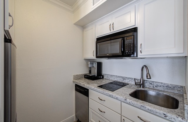 kitchen with black microwave, ornamental molding, a sink, white cabinetry, and stainless steel dishwasher