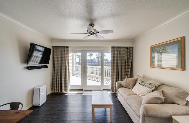 living area with dark wood-type flooring, ornamental molding, and ceiling fan