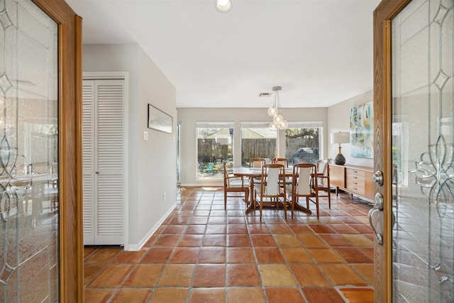 dining area featuring tile patterned flooring, visible vents, and baseboards