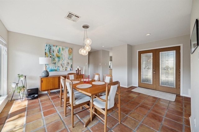 dining space with tile patterned floors, baseboards, visible vents, and french doors