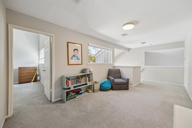 rec room featuring carpet floors, baseboards, and visible vents