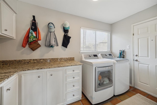 laundry room featuring tile patterned flooring, cabinet space, and washer and dryer