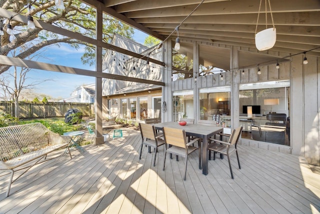 deck featuring outdoor dining space and fence