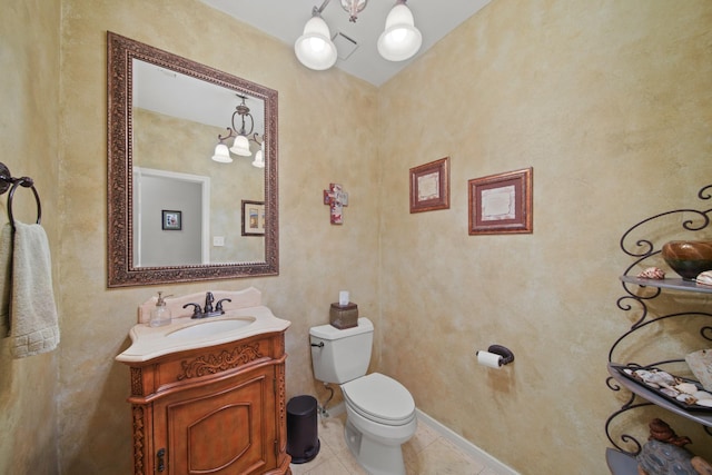 half bathroom with vanity, visible vents, baseboards, tile patterned flooring, and toilet