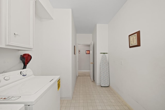 clothes washing area featuring cabinet space, baseboards, and separate washer and dryer