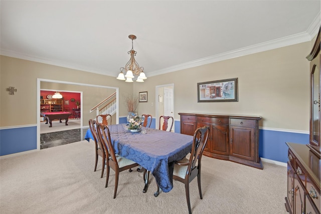 dining space with baseboards, light colored carpet, a chandelier, and crown molding