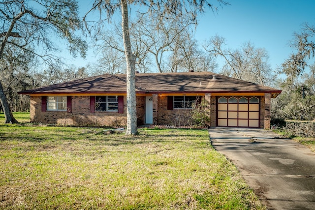 single story home featuring driveway, a garage, a front lawn, and brick siding