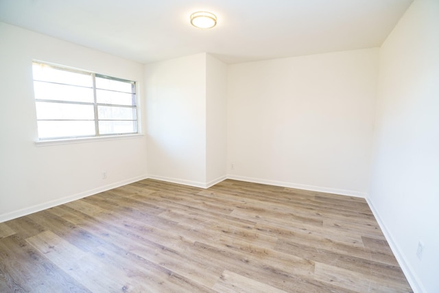 empty room with wood finished floors and baseboards