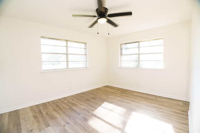 empty room with light wood-style floors, ceiling fan, and baseboards