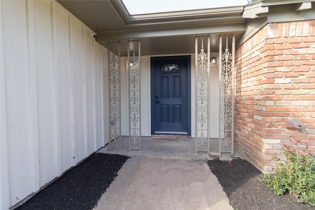 doorway to property featuring brick siding