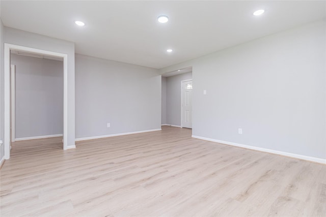 empty room featuring recessed lighting, light wood-style flooring, and baseboards