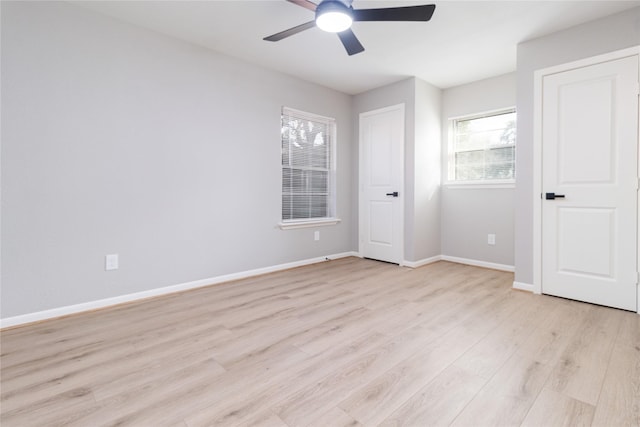 unfurnished bedroom with light wood-style floors, ceiling fan, and baseboards