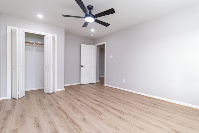 unfurnished bedroom with baseboards, a closet, recessed lighting, and light wood-style floors