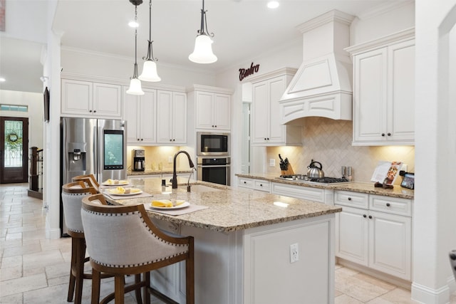 kitchen with stone tile floors, appliances with stainless steel finishes, custom exhaust hood, decorative backsplash, and crown molding